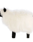 Faire's Tibetan Lamb Sheep features a fluffy white lamb body with black face, ears, and legs, shown in profile against a plain white background—an adorable nursery accessory.