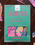 Colorful paper bird garland from Bungalow Furniture on wooden table, festive decor for birthdays or celebrations.