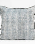 The Blossom Block Print Euro Sham by Faire features a subtle vertical blue and white pinstripe pattern on a light background, offering an elegant accent for artisan pillows or bohemian bedding on any plain white surface.