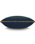 The Fairuza Embroidered Pillow by Eastern Accents features a navy blue linen base with green and blue embroidery and yellow-gold fringe, displayed from the side against a white background.