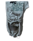 The Flap/Snap AirJump Pant by Free City (sparrow, LLC) features a light gray sunfade wash, drawstring waistband, front pockets, and an upside-down dark green FREECITY print. The shorts are displayed flat on a white background.