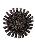 The Fractal Black Flower by Faire is a dark chocolate sculpture with ruffled, petal-like layers arranged in a circular pattern, similar to ceramic flower wall hangings, shown against a white background.