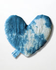 The Faire Heart Eye Pillow is a heart-shaped cotton eye pillow with a blue and white tie-dye pattern and a small blue fabric loop at the bottom, shown against a plain white background.
