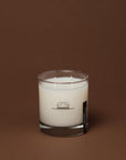 High Horse two-wick soy wax candle in a clear glass jar with a hat logo, set against a dark brown background.