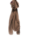 The BASIC GOODNESS HOODIE by Free City (sparrow, LLC) is an oversized brown pullover with a front pocket, casually draped on a hook against a white background, highlighting its laid-back style and made in the USA.