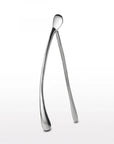 The Faire Wishbone /Large is a shiny, silver wishbone-shaped decor piece crafted from sand cast aluminum with smooth, rounded ends—an elegant handcrafted gift that stands upright on any surface.