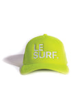 The Le Surf Hat by Ping Pong Surf Club is a neon yellow-green mesh trucker cap with "LE SURF." embroidered in white on the front, shown against a white background.