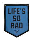 A blue Oxford Pennant flag with black trim, bold black "LIFE'S SO RAD" text, and a small Maladroit-era =W= logo near the bottom. Product name: Life's So Rad.