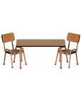 The Maileg Table and Chairs set features two small beech wood chairs with metal legs and a matching rectangular table—perfect for adding minimalist charm to any Mouse hole Farmhouse décor.