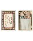 Maileg’s “Twins, Baby mice in matchbox” gift features twin baby mice snuggled under a striped blanket in a vintage-style box labeled "Baby Twins—The Match Factory," decorated with two mouse illustrations.