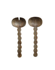 Bloomingville's Mango Salad Servers feature two natural carved mango wood pieces—one spoon and one fork style—each with scalloped handles and showcasing the wood's beautiful grain.