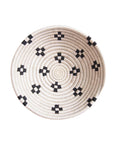 Round sisal bowl by Faire with black geometric spirals, perfect as wall art or unique accent for any room.