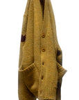 SuperYumm golden yellow Norwegian wool pocket cardigan with large front pockets and dark sleeve patch.