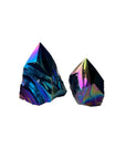 The Blue Ocean Traders Aura Black Obsidian Point features two striking crystals with pointed tips, showcasing a sleek black finish on a white background—a sculptural addition to any collection.
