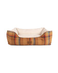 Rectangular Pendleton Kuddler bolster dog bed with plaid exterior and cream-colored faux fur interior.