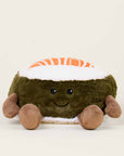 The Salmon Sushi Warmies by Faire is a lavender-scented plush toy shaped like a smiling sushi roll with a brown base, white rice, orange-striped top, and four small limbs, shown against a plain light background.