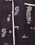 Juliet SS Top with white, beige, and blue embroidery on dark fabric by Sea New York at Bungalow Furniture & Accessories.