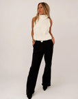 Shelly Sweater by Kerri Rosenthal in a casual look, paired with black pants, hands in pockets.