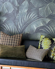 Bungalow Furniture & Accessories Beachcomer Check Pillow 22x22 on a black leather sofa with dark tropical wallpaper.