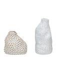 The Creative Co-op Organic Shaped Vase features textured stoneware; one vase is tan with a spiked pattern, while the other has a white reactive glaze, irregular shape, and rough surface.