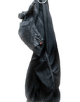 A pair of oversized Matte/Satin Biggy Pants by Free City (sparrow, LLC) in black hangs from a metal ring against a white background, with one leg tucked inside out.