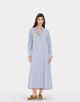 Blue and white striped Xirena Boden dress with long sleeves, styled with brown shoes for a chic, relaxed look.
