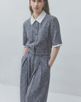 SUNCOO Lino gray textured pantsuit with white blouse, modern tailored look, neutral background.