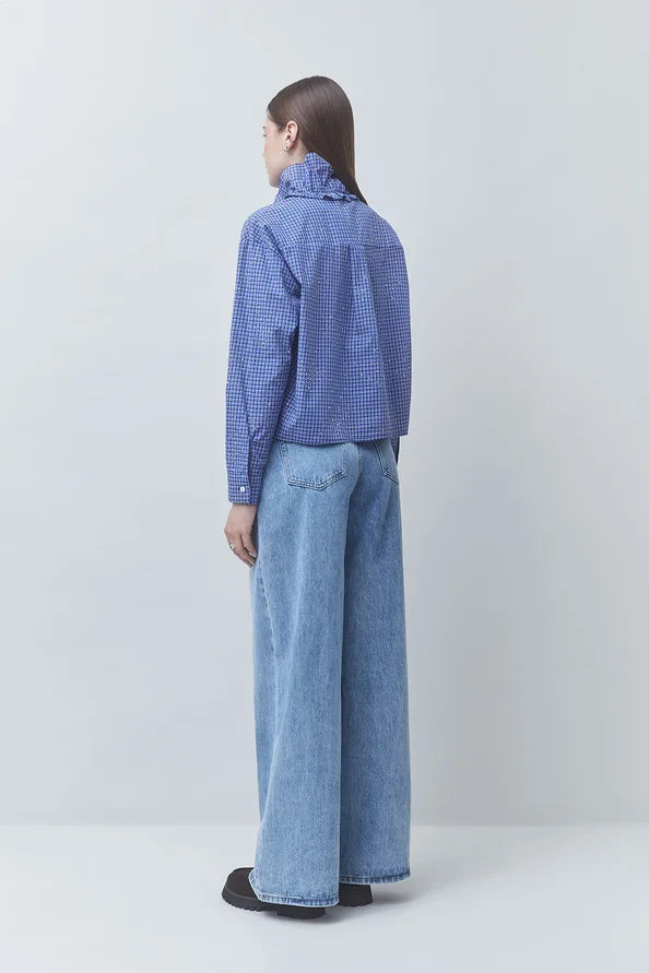 Checked Victorian-style shirt and wide-leg jeans by SUNCOO Lyes, back view against light background.