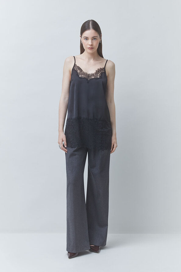 SUNCOO Lune Shirt in white with wide-leg gray trousers, relaxed modern style against a pale backdrop.