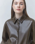 SUNCOO LENNOX kaki jacket with straight brown hair model, styled in a minimal, light-toned setting.