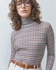 SUNCOO Manech check-print tee in neutral tones styled with beige pants and brown belt, casual modern look.
