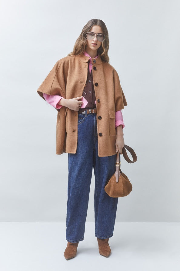 SUNCOO Ezra coat in pink over a shirt and jeans, styled with brown boots and bag, minimal studio setting.