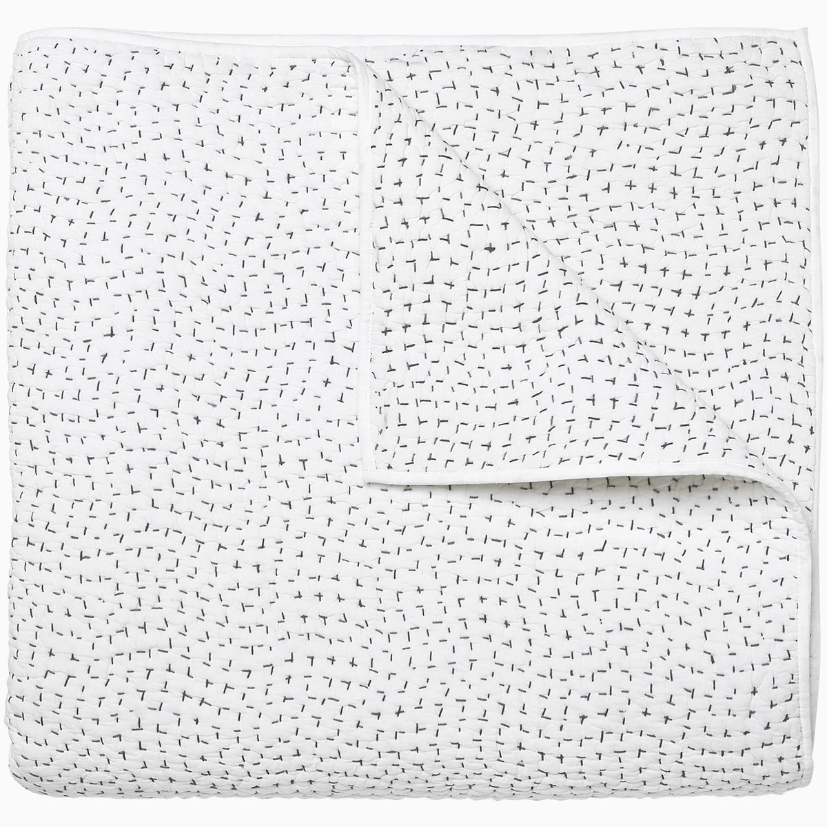 The John Robshaw Hand Stitched Coverlet King is a white cotton voile quilt, neatly folded and featuring subtle black cross stitches scattered throughout, giving it a soft, textured look.