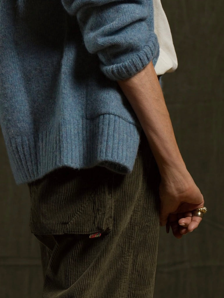 Light blue knit sweater worn with olive green Free City Cashmereblend loose drawcord biggy corduroy pants.