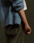 Light blue knit sweater worn with olive green Free City Cashmereblend loose drawcord biggy corduroy pants.