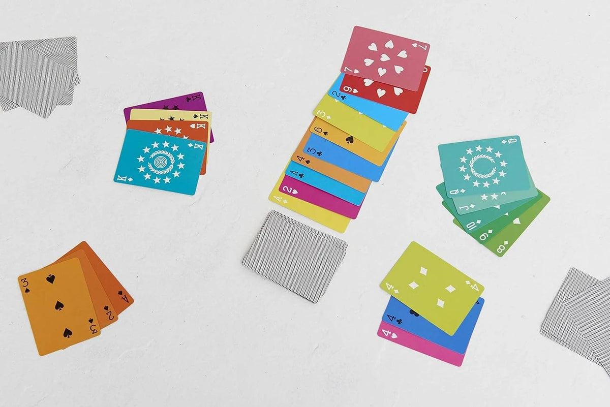 Artistic playing cards featuring numbers and stars, gray-backed, by Hachette Book Group for Bungalow Furniture.
