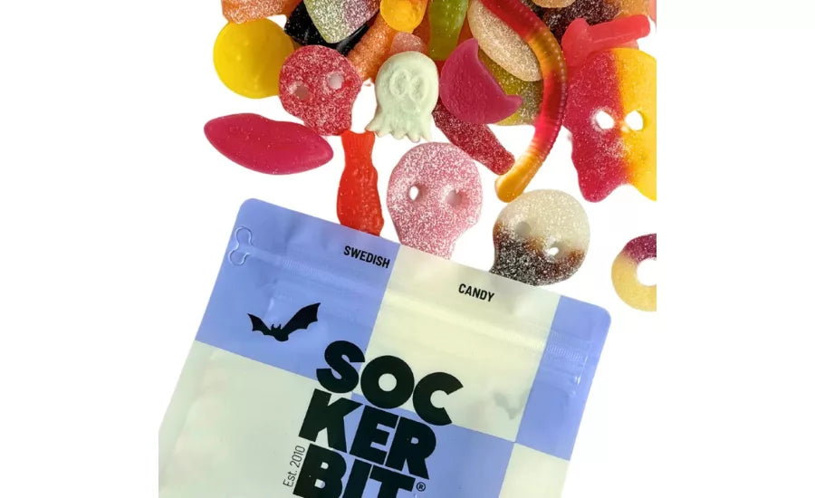 Spooky Gummy Mix skulls and worms spilled from a blue and white pouch by Bungalow Furniture &amp; Accessories.