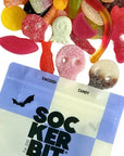 Spooky Gummy Mix skulls and worms spilled from a blue and white pouch by Bungalow Furniture & Accessories.