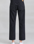 Black Denimist LUCY BF straight-leg jeans styled with white shoes, shown against a light gray background.