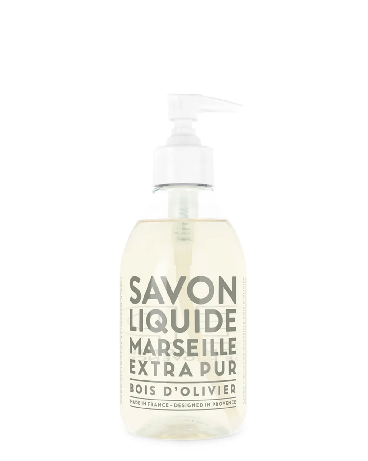 A clear recyclable plastic bottle of Cie Luxe Brands Liquid Soap 10oz, made from vegetable oils with a Bois d’Olivier scent. The label is white with gray text and the light yellow soap shows through.