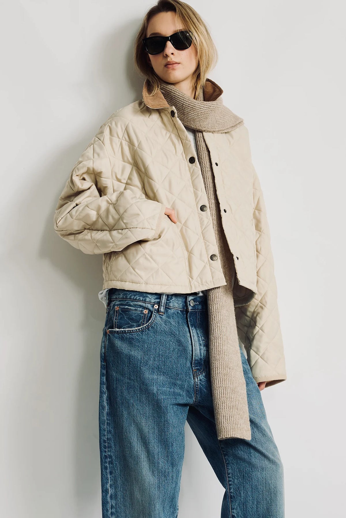 Denimist Faulkner quilted jacket with knit scarf, styled casually outdoors by a white wall.