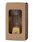 The Maileg Blender, a miniature toy with a yellow base and clear container, comes in a brown grid-patterned box labeled "furniture" by Maileg—ideal for bunny kitchens or rabbit toy setups.