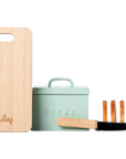 The Maileg Bread box w. utensils set by Maileg includes a mint green bread box labeled "Bread," a small wooden cutting board, a toy bread knife, and a sliced toy loaf—ideal accessories for any Maileg dollhouse.