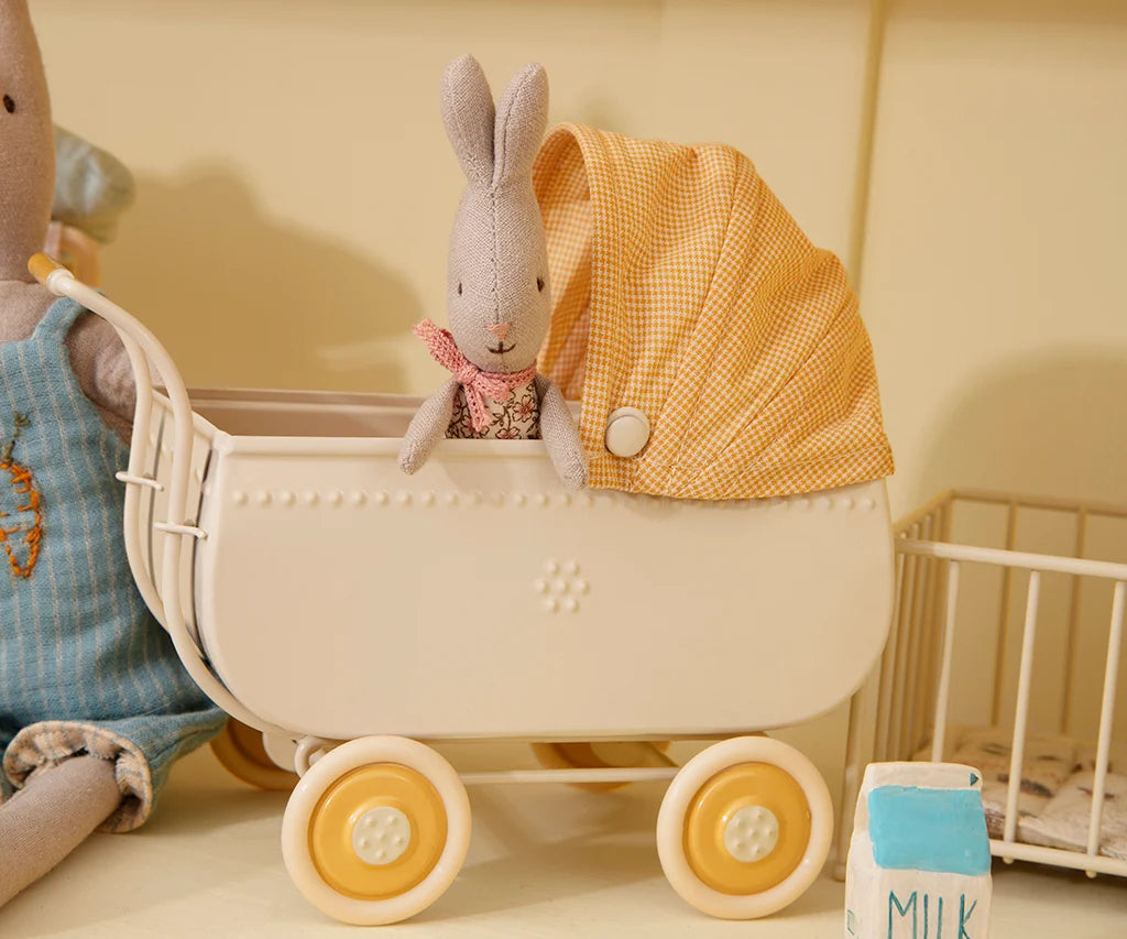 Maileg Micro Pram in yellow with tiny bunny wearing a pink scarf, styled with milk carton. Bungalow Furniture & Accessories.