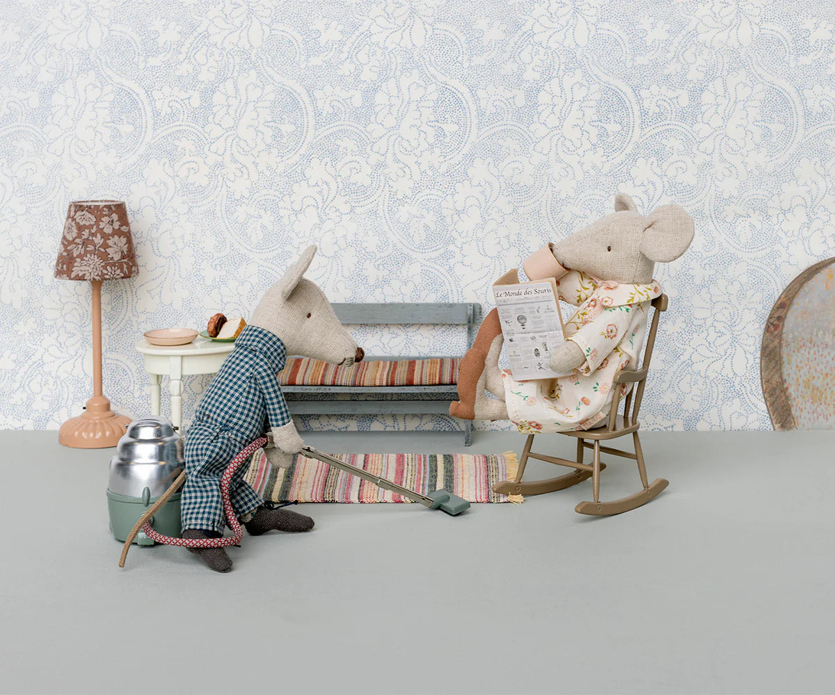 Maileg mouse vacuums in a robe while another reads in a vintage-inspired setting; whimsical decor by Bungalow.