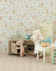 Three Maileg toy mice in a vintage-style kitchen: one stands at the sink, one in striped pajamas reaches for the counter, and another sits at a table set with bread, a blue teapot, dollhouse furniture, and the adorable Maileg High Chair.