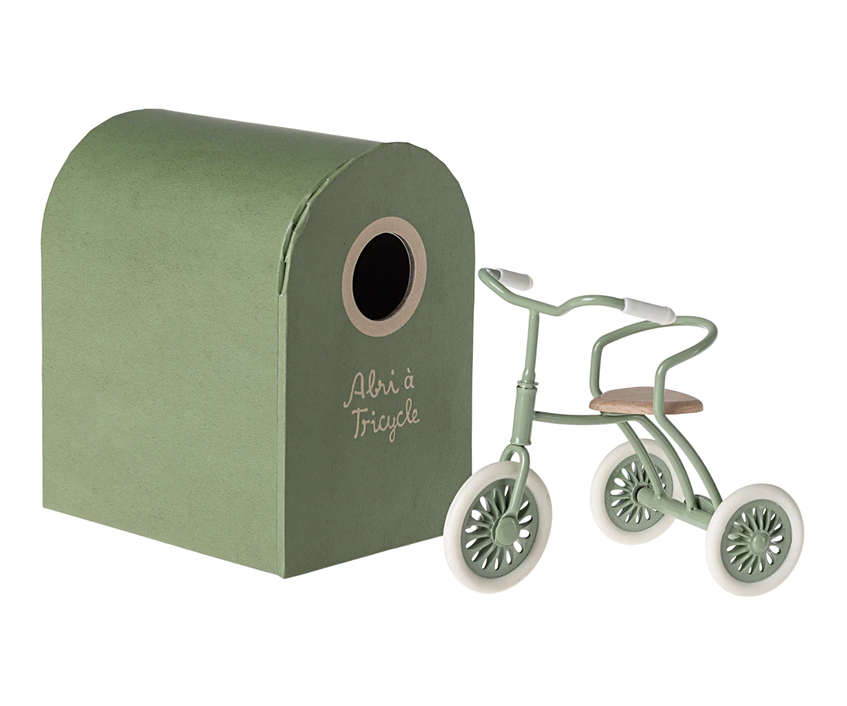 Green Maileg tricycle with matching shed, charming storage for mouse toys; perfect for playful kids’ rooms.