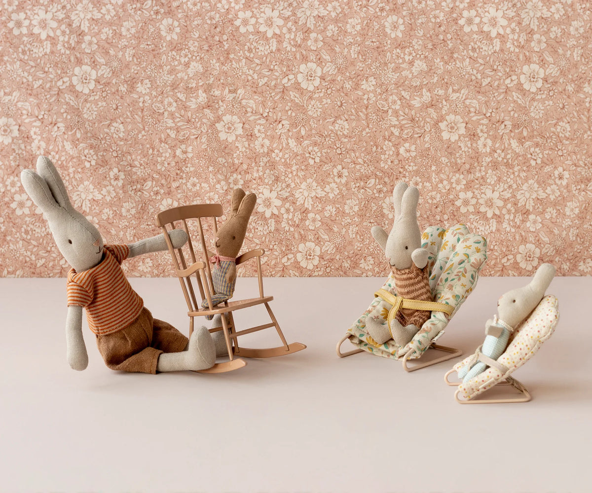 Maileg bunnies on Micro Babysitter seats with floral wallpaper, playful nursery decor from Bungalow Furniture & Accessories.