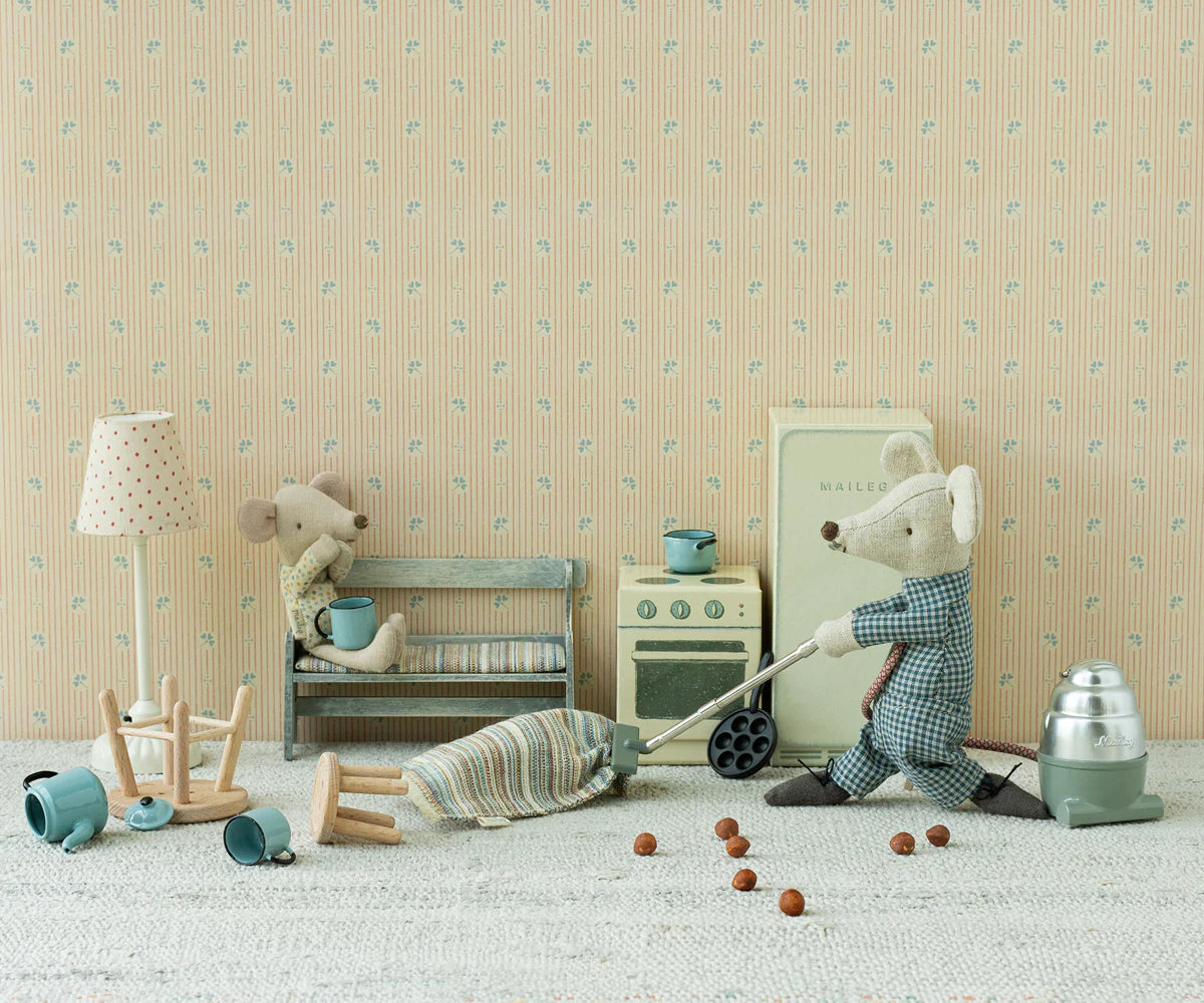 Maileg toy mice with vacuum cleaner in a playful, patterned kitchen setting by Bungalow Furniture &amp; Accessories.