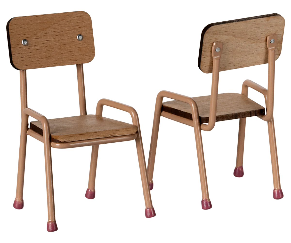 Two small Maileg Table and Chairs by Maileg, featuring beech wood frames with light brown seats and beige metal legs tipped in pink, are placed side by side—one forward, one angled backward—in this charming set.
